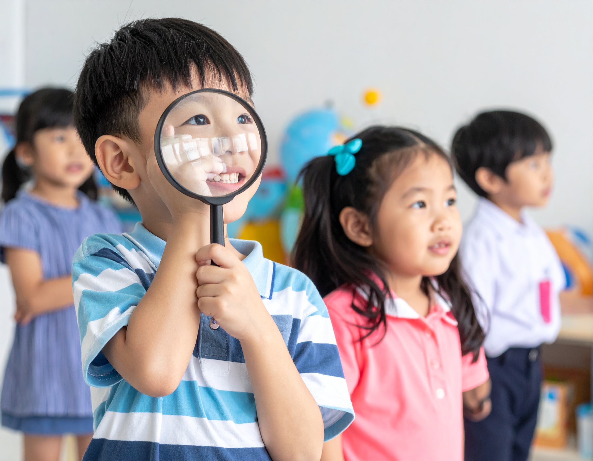 Child exploring with magnifying glass