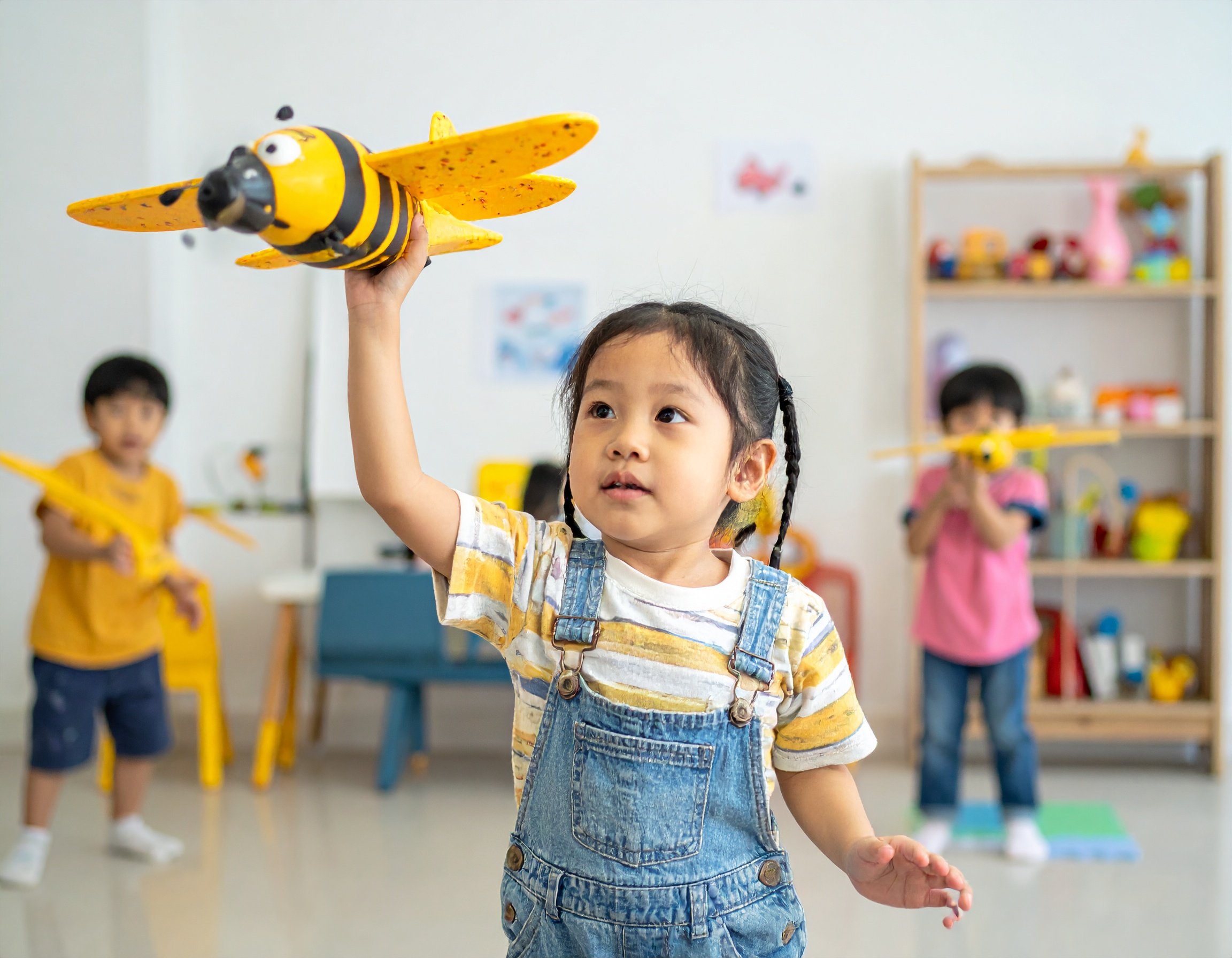 Little Tinkerer playing with bee airplane